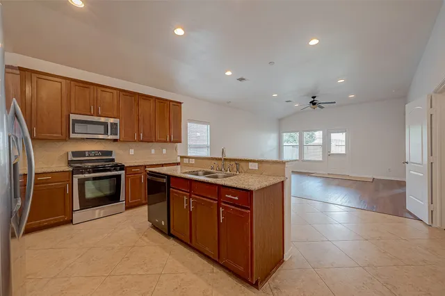 a kitchen with a stove a sink and a refrigerator