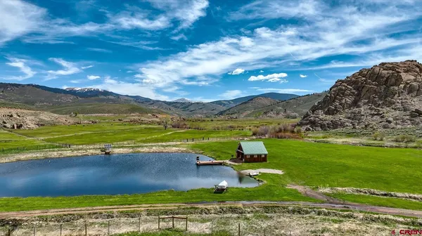 a view of a lake with houses in the back