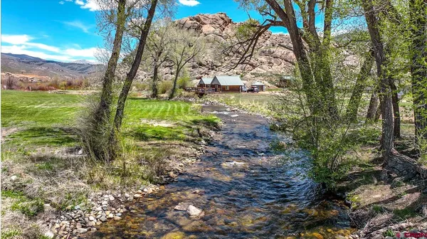 a view of a backyard with wooden fence
