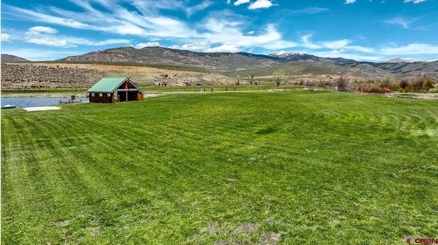 a view of a lush green hillside and houses