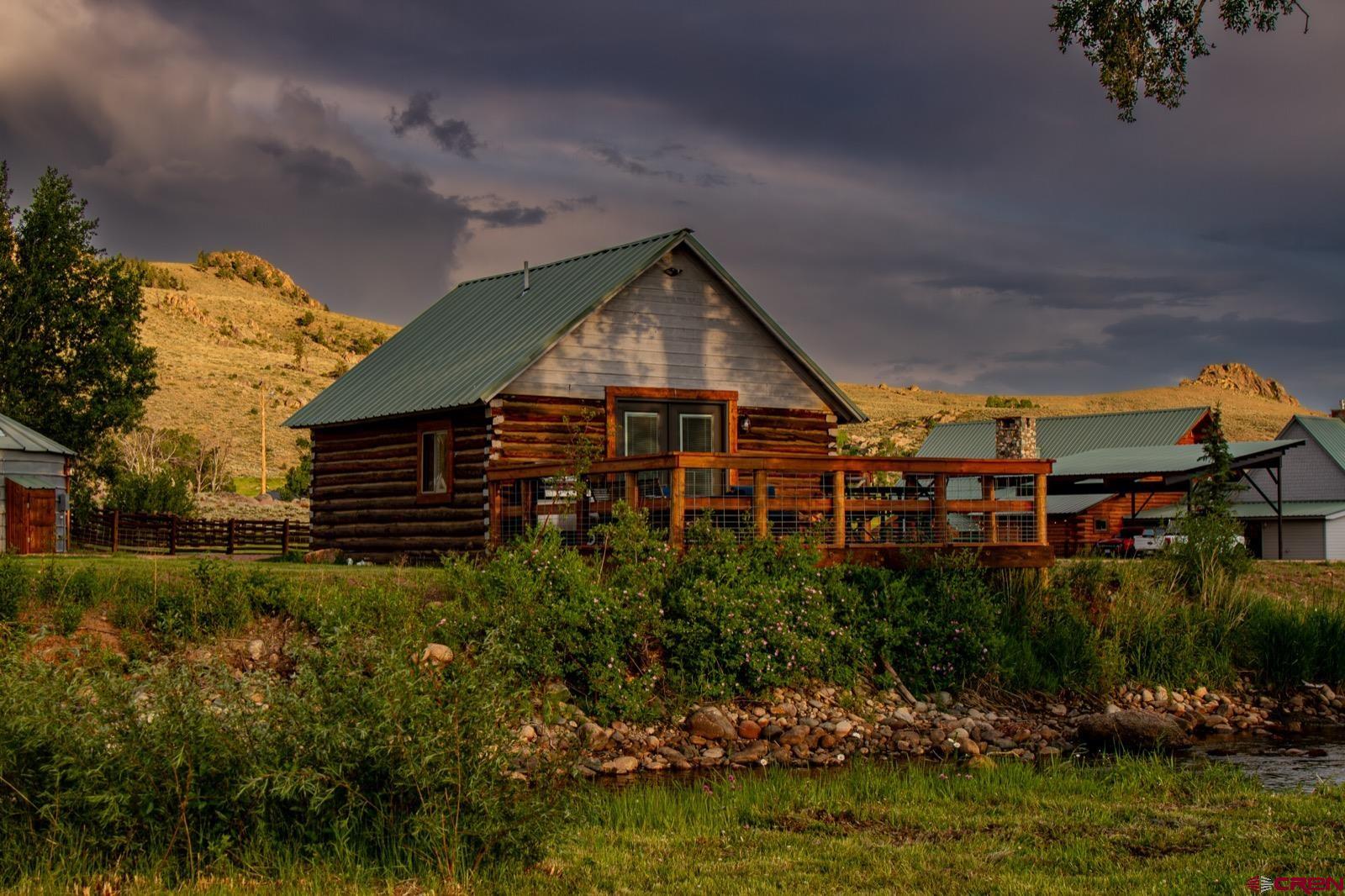 5291 County Road 76 Parlin, CO 81239 - Photo 42 of 42 a view of a house with a yard and potted plants