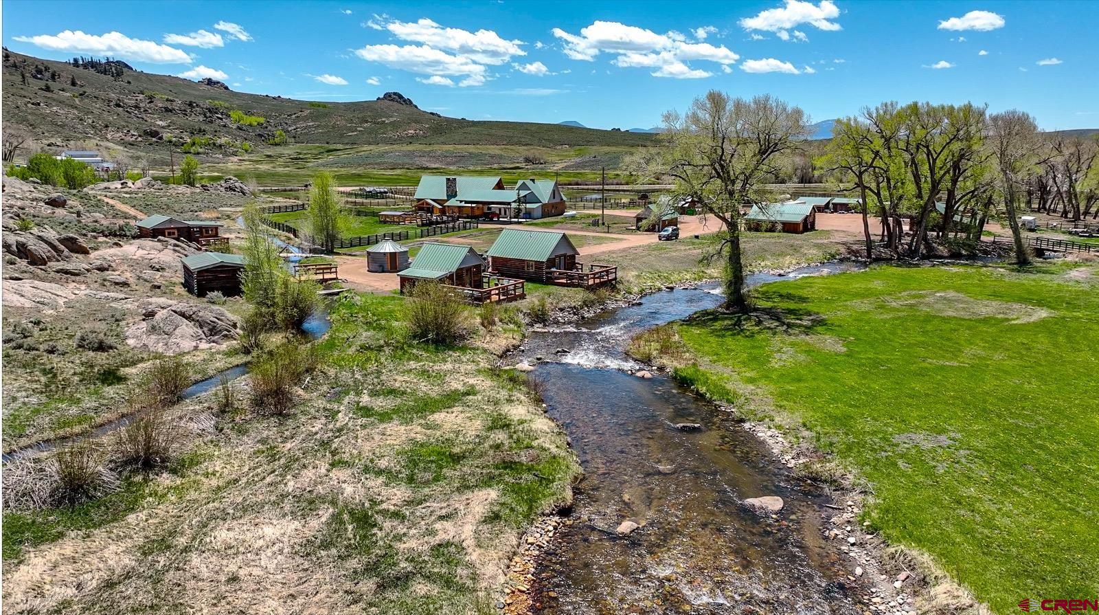 5291 County Road 76 Parlin, CO 81239 - Photo 5 of 45 a view of a big yard with lawn chairs potted plants and large tree