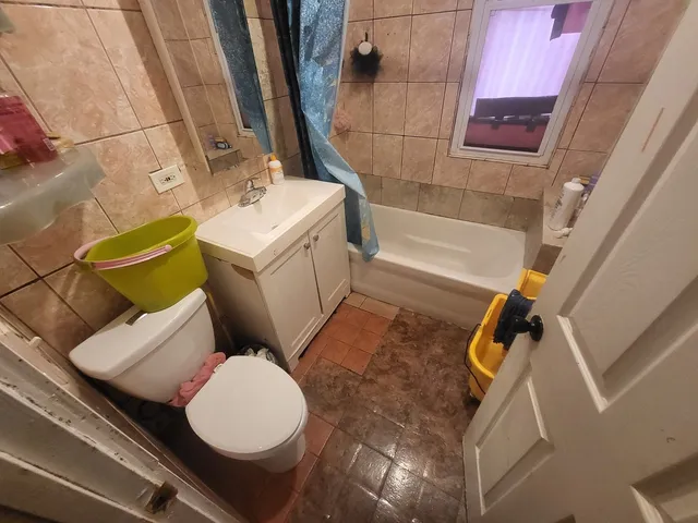 a view of a closet with wooden floor