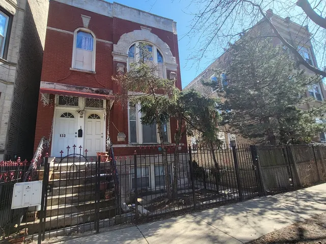 a front view of a house with a garden