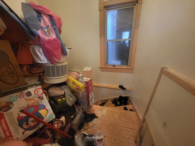 a bedroom with bed and a chandelier