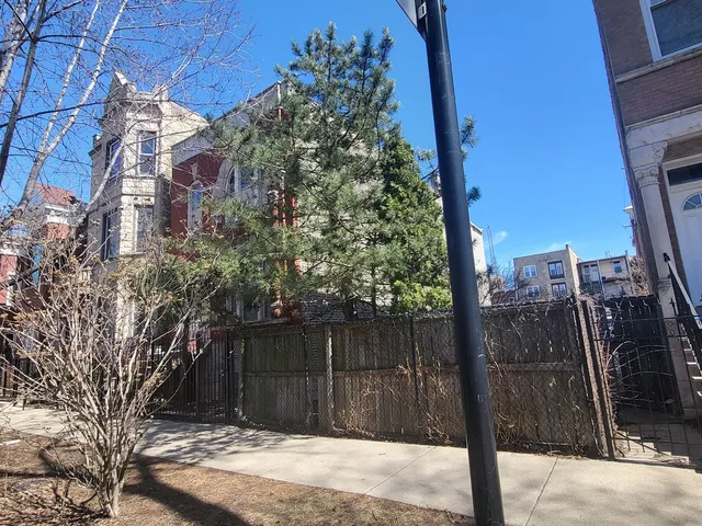 a wooden fence with tall trees