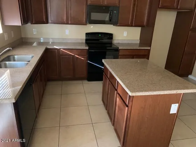 a kitchen with a sink and a stove top oven