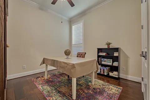 a view of a workspace with furniture and a book shelf