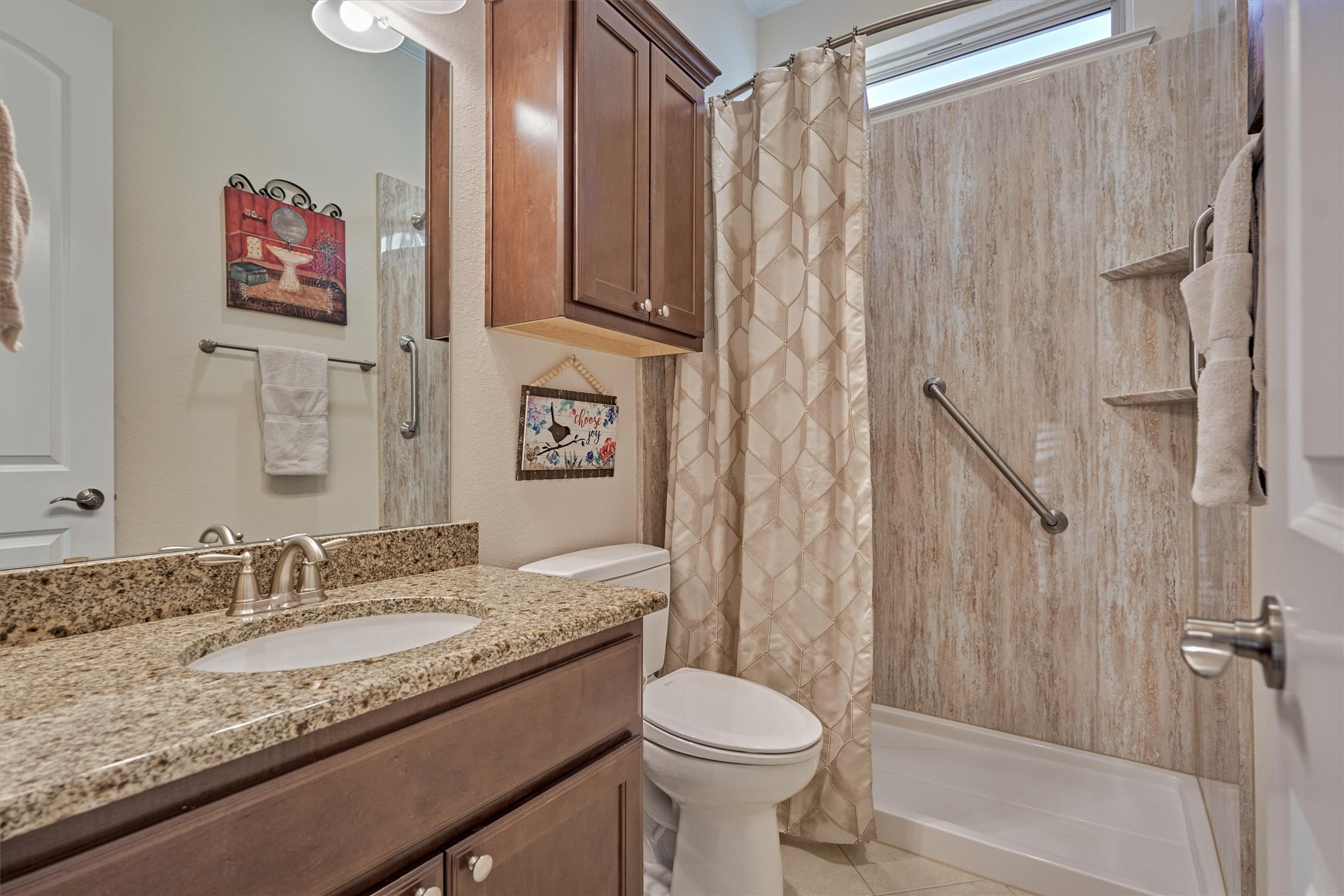 8827 Leaning Hollow Lane Spring, TX 77379 - Photo 16 of 49 Full bath positioned between bedroom 1 and 2. Granite counters. Recently remodeled shower with grab bars. Extra cabinet storage above the commode.