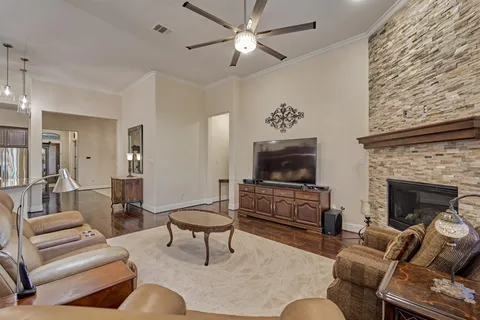 a living room with furniture a flat screen tv and a fireplace