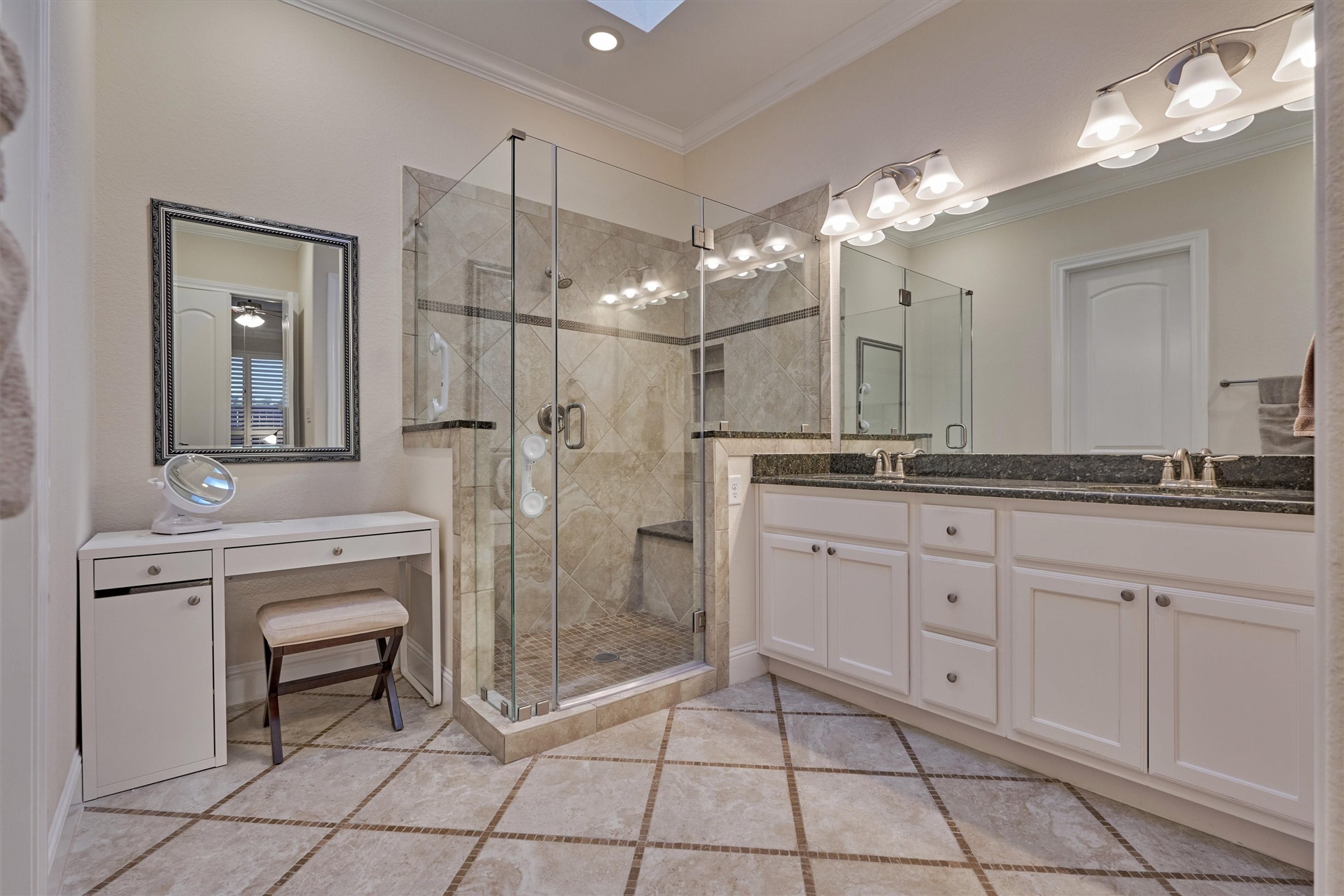 8827 Leaning Hollow Lane Spring, TX 77379 - Photo 34 of 49 Beautiful primary bath with micro tile accented floors, granite counters and male up vanity area.