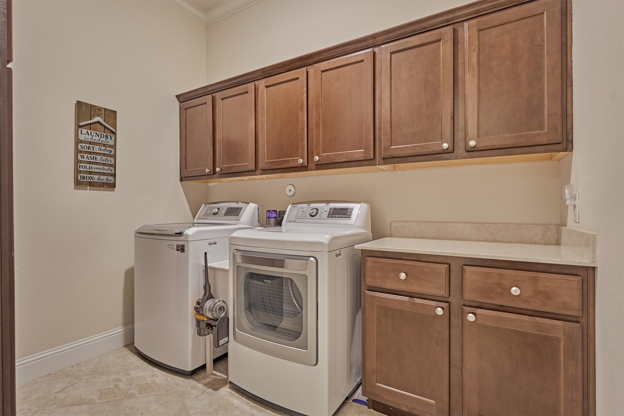 8827 Leaning Hollow Lane Spring, TX 77379 - Photo 37 of 49 Oversized laundry with cabinets on both sides. It is plumbed for a sink under the counterr area.