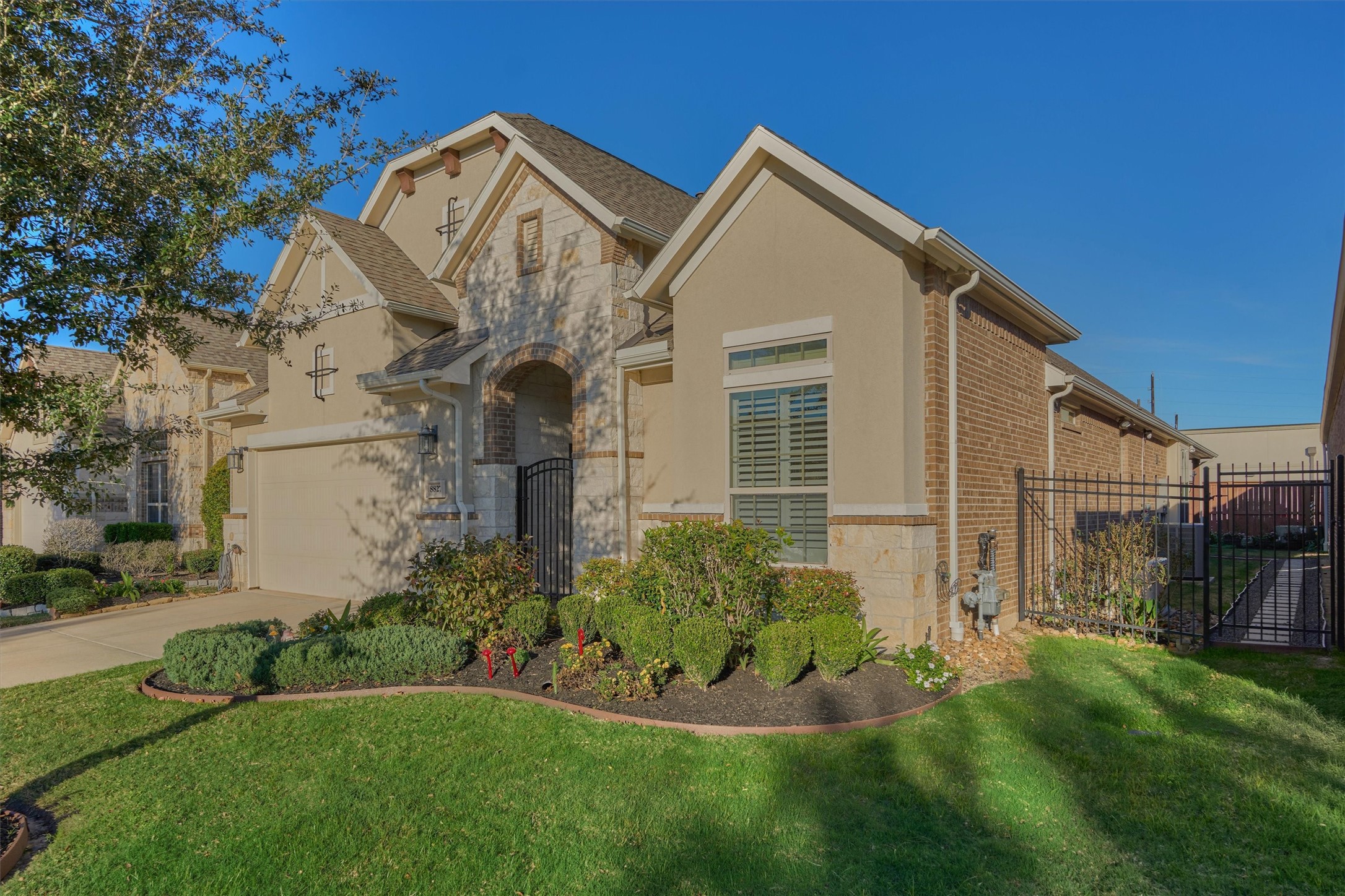 8827 Leaning Hollow Lane Spring, TX 77379 - Photo 4 of 49 Nicely landscaped with greenery and color. Full sprinklers. Brick, stone and stucco exterior.