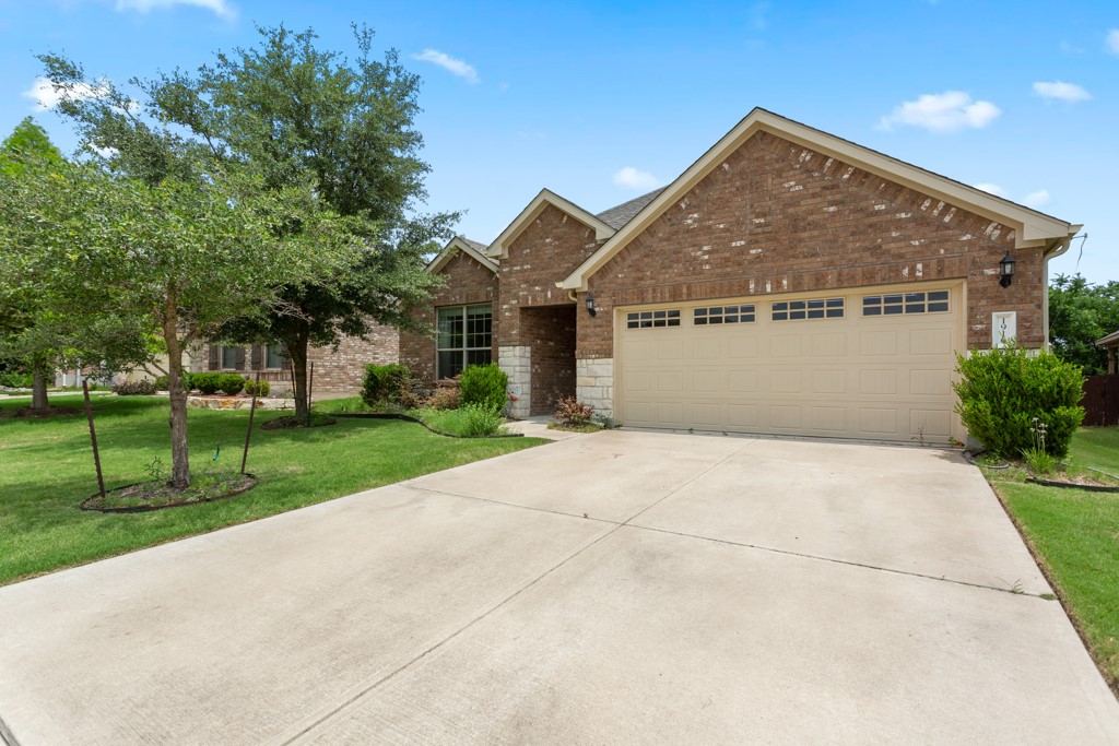 1916 Elaina Loop Leander, TX 78641 - Photo 2 of 23 a front view of house with yard and green space