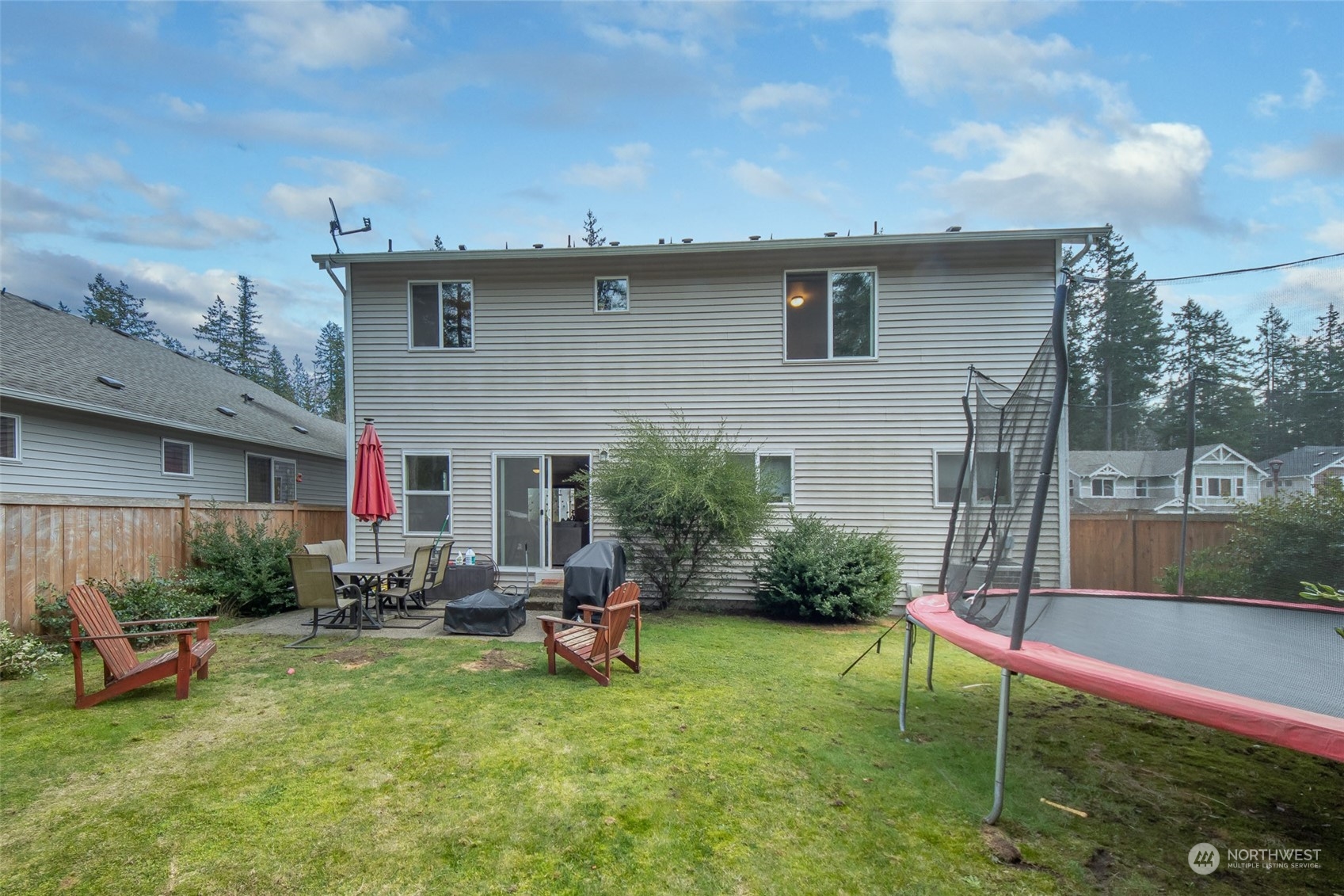 4644 Chanting Circle Southwest Port Orchard, WA 98367 - Photo 17 of 26 a backyard of a house with table and chairs