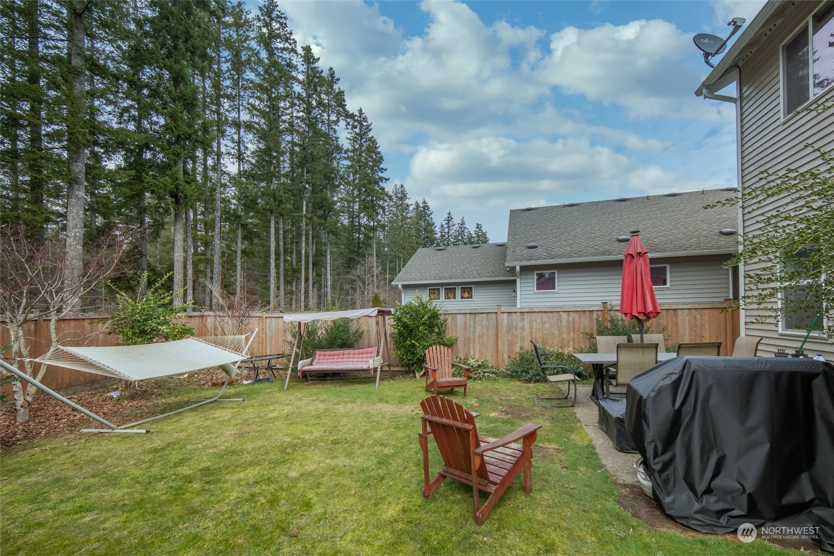 4644 Chanting Circle Southwest Port Orchard, WA 98367 - Photo 22 of 26 a view of backyard with outdoor seating a patio and plants
