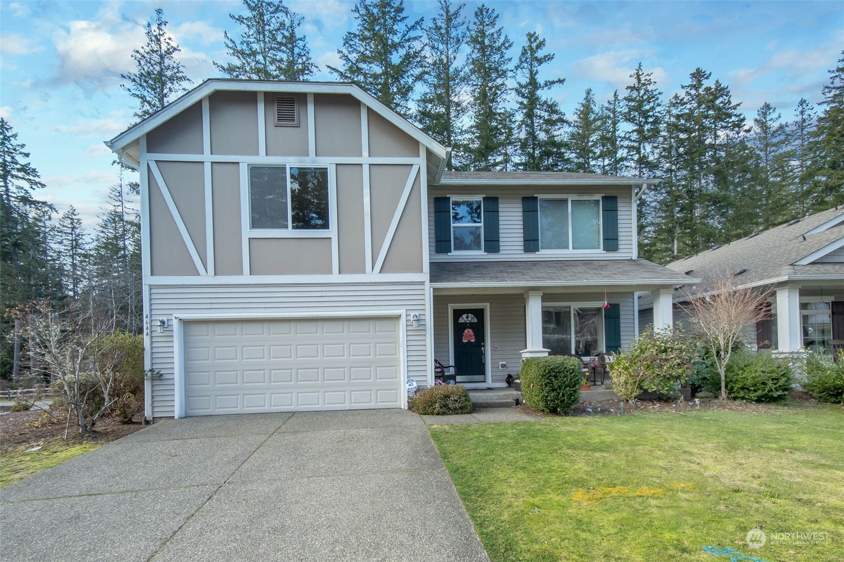 4644 Chanting Circle Southwest Port Orchard, WA 98367 - Photo 24 of 26 a front view of a house with a yard and garage