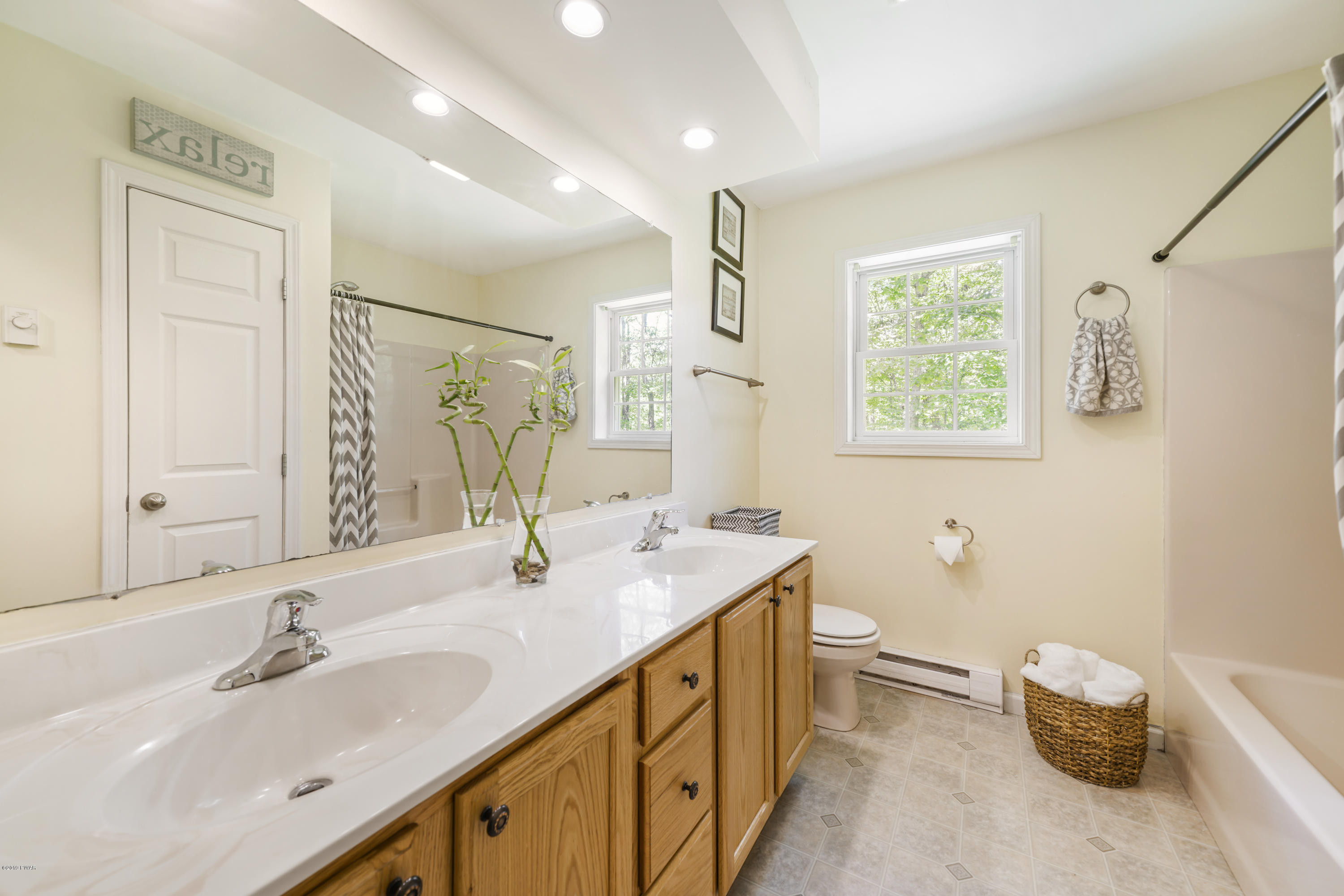 129 Butternut Road Milford, PA 18337 - Photo 20 of 26 a bathroom with a double vanity sink toilet and a mirror