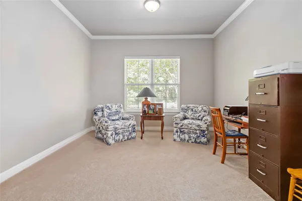 a bedroom with windows and cabinet