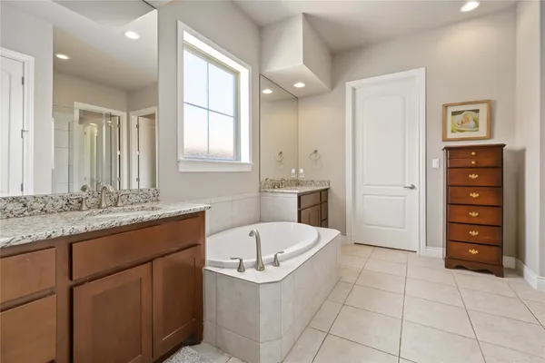 a bathroom with a granite countertop sink a toilet and bathtub