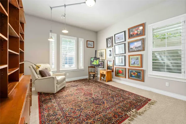 a living room with furniture rug and window