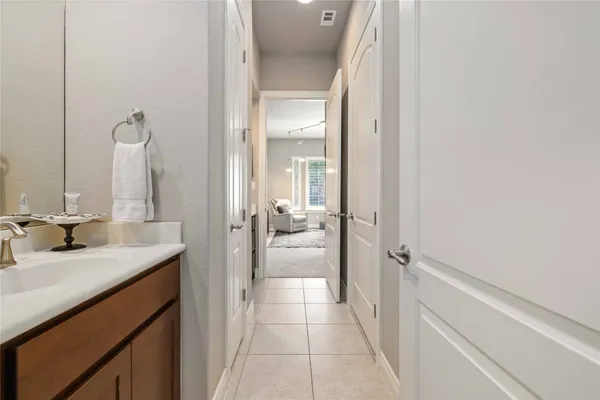 a en suite bathroom with a granite countertop sink and a mirror