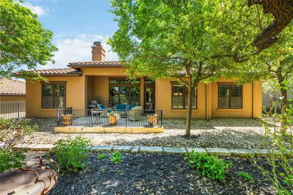 a view of a house with backyard and sitting area