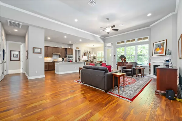 a living room with furniture and a wooden floor