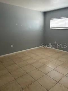 a view of an empty room and a window