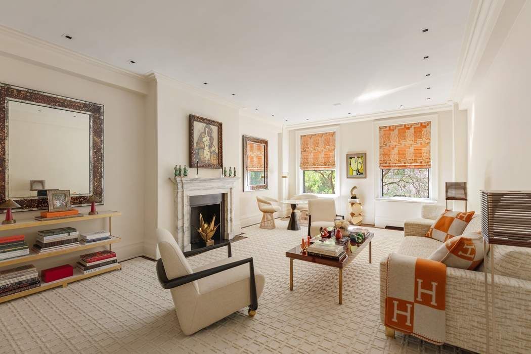 29 East 64th Street, Unit 4C Manhattan, NY 10065 - Photo 2 of 9 a living room with furniture fireplace and flat screen tv