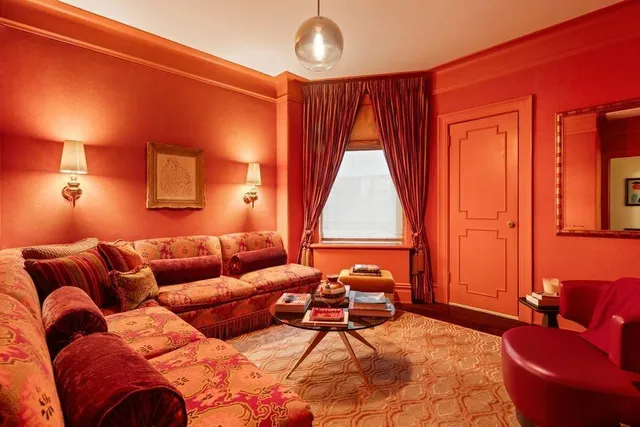 a living room with furniture chandelier and a window