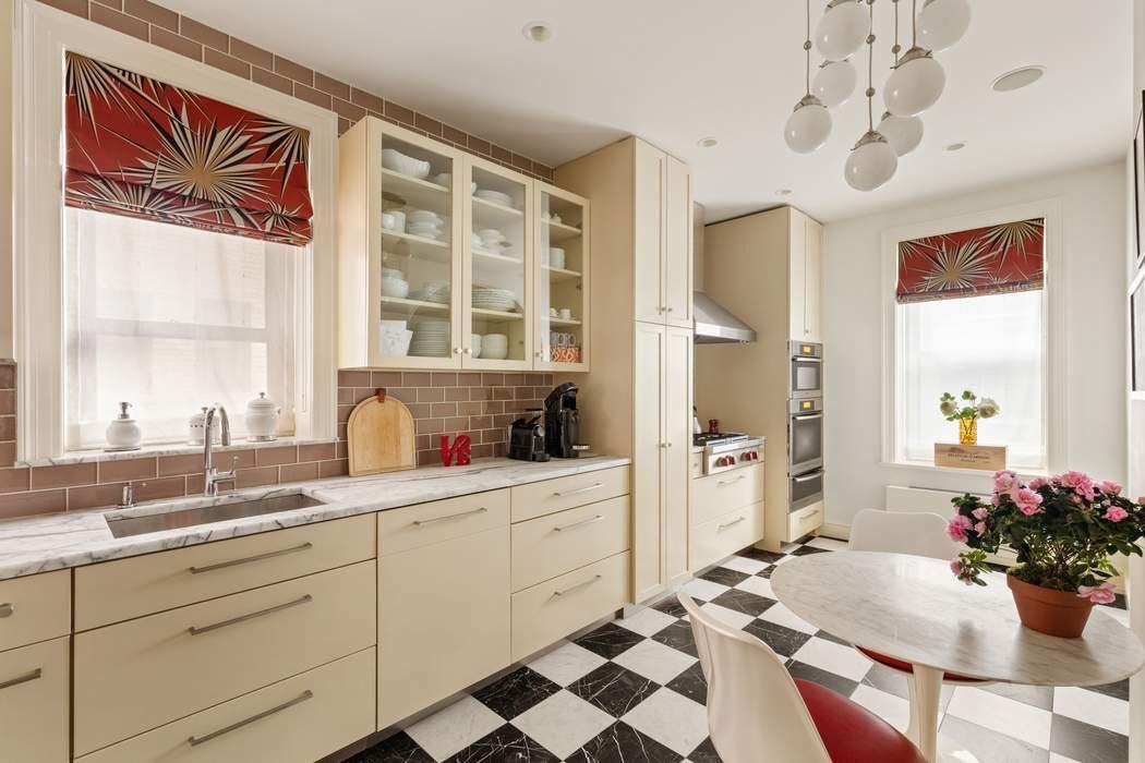 29 East 64th Street, Unit 4C Manhattan, NY 10065 - Photo 5 of 9 a kitchen with a sink stove and window