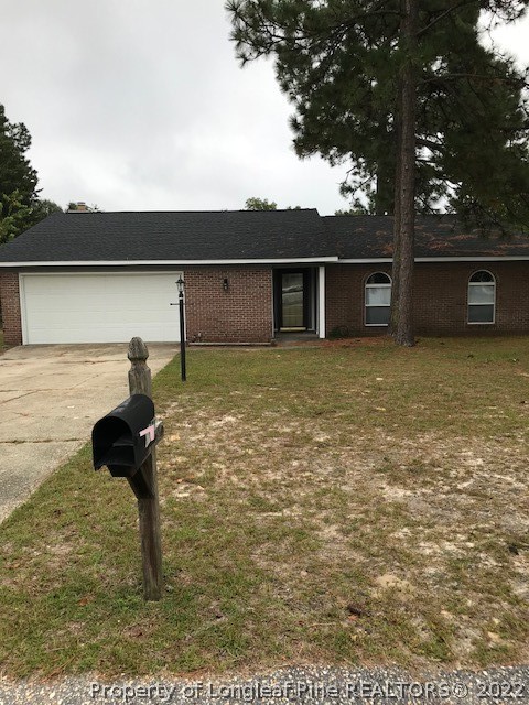 6932 Wickersham Road Fayetteville, NC 28314 - Photo 1 of 2 a backyard of a house with table and sofas