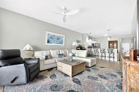 a living room with furniture a rug and a table