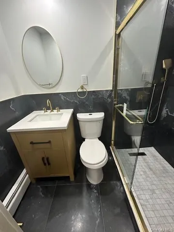 a bathroom with a toilet sink and mirror