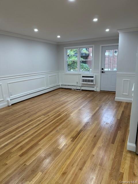3524 Cambridge Avenue, Unit C Bronx, NY 10463 - Photo 5 of 10 Spare room with a decorative wall, light wood-style floors, recessed lighting, crown molding, and a baseboard heating unit