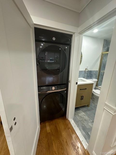 3524 Cambridge Avenue, Unit C Bronx, NY 10463 - Photo 6 of 10 Laundry room featuring light wood-style floors and stacked washing machine and dryer