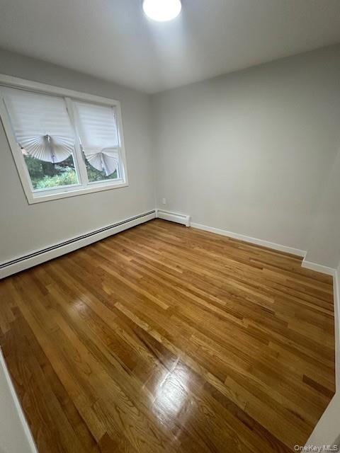 3524 Cambridge Avenue, Unit C Bronx, NY 10463 - Photo 8 of 10 Unfurnished room with light wood-style flooring and a baseboard heating unit
