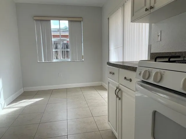 a kitchen with a stove and a white cabinet