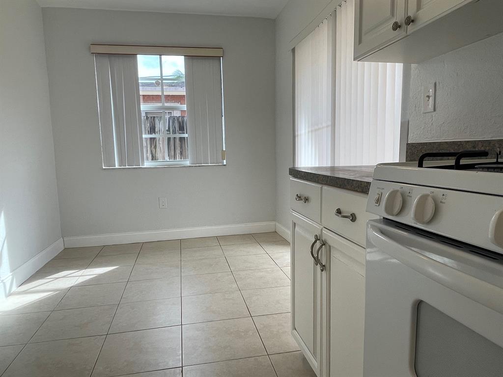 8510 Sunset Strip Sunrise, FL 33322 - Photo 14 of 21 a kitchen with a stove and a white cabinet