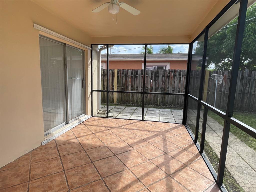 8510 Sunset Strip Sunrise, FL 33322 - Photo 15 of 21 a bedroom with a bed and a window