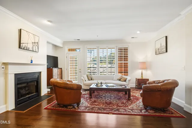 a living room with furniture wooden floor and a fireplace