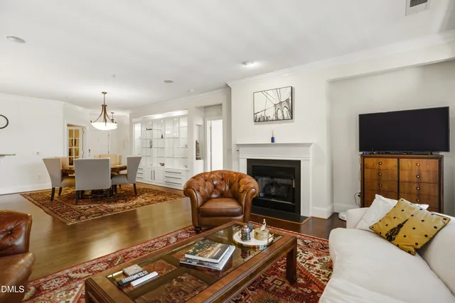 a living room with furniture fireplace and flat screen tv