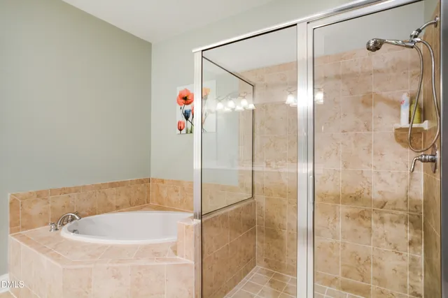 a bathroom with a bathtub and a shower