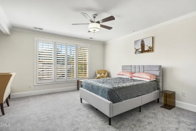 a bed sitting in a bedroom next to a window