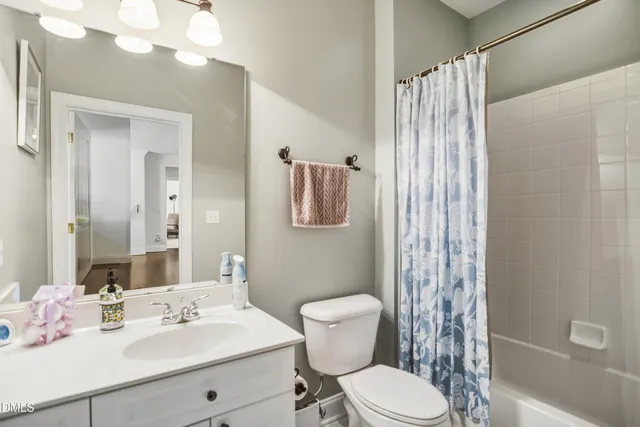 a bathroom with a sink vanity mirror and toilet