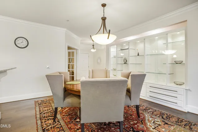 a living room with couches and a chandelier