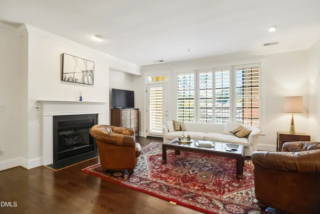 a living room with furniture a fireplace and a large window