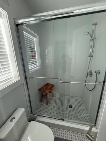 a bathroom with a shower and a toilet