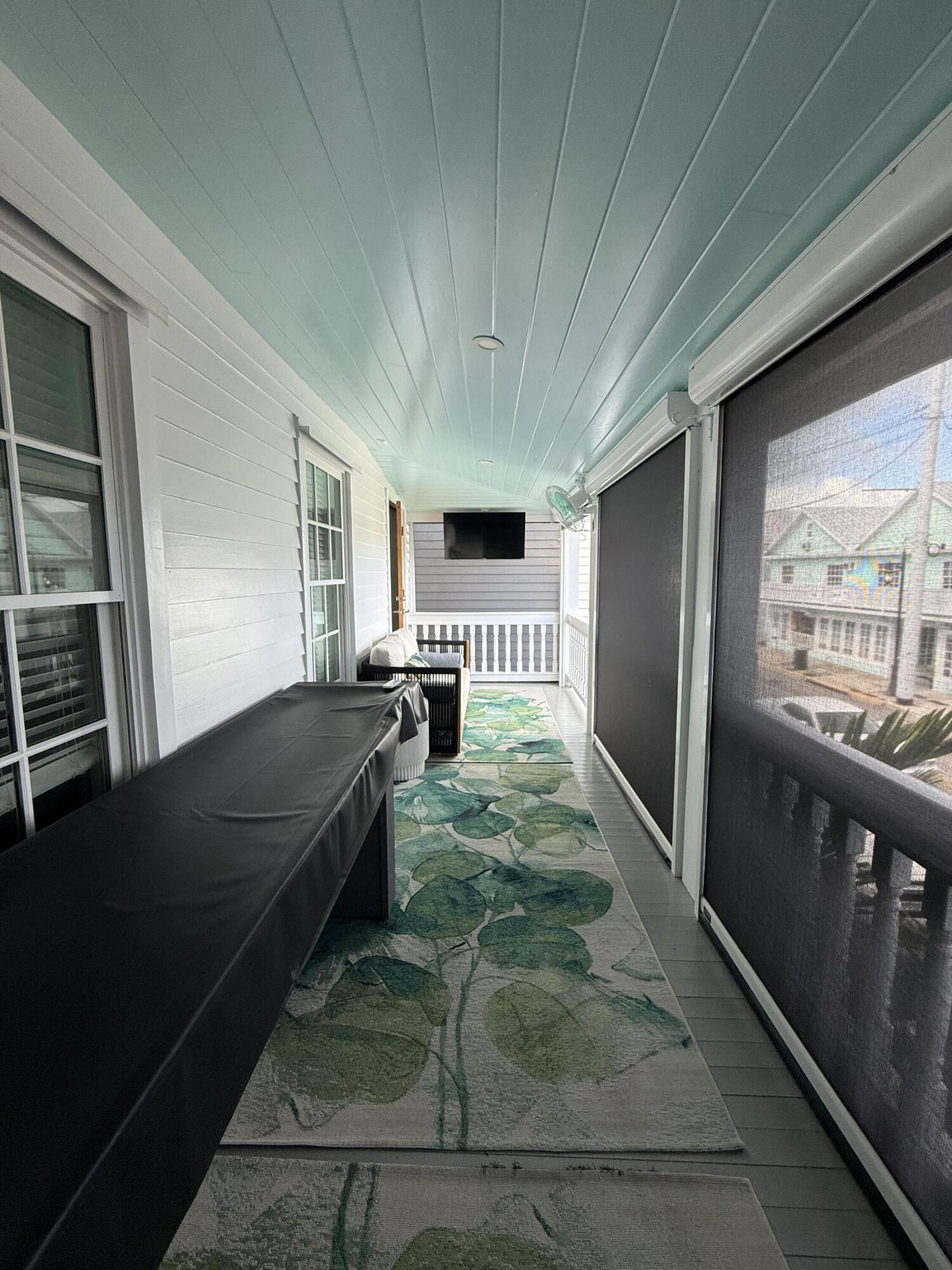 1116 Truman Avenue, Unit 1 Key West, FL 33040 - Photo 16 of 18 a living room with a couch a rug kitchen view and a large window